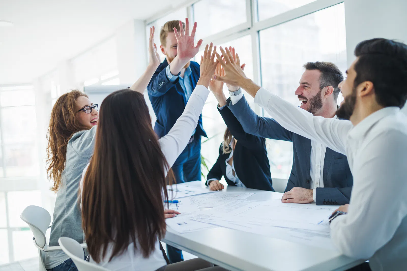 a group of people raising their hands
