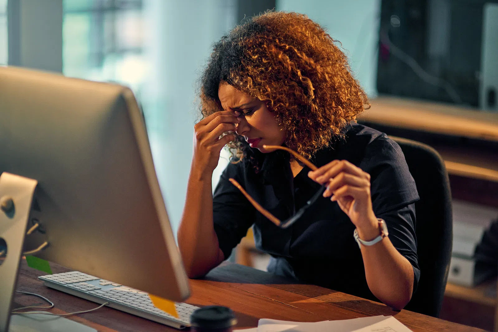a person sitting at a desk with a laptop