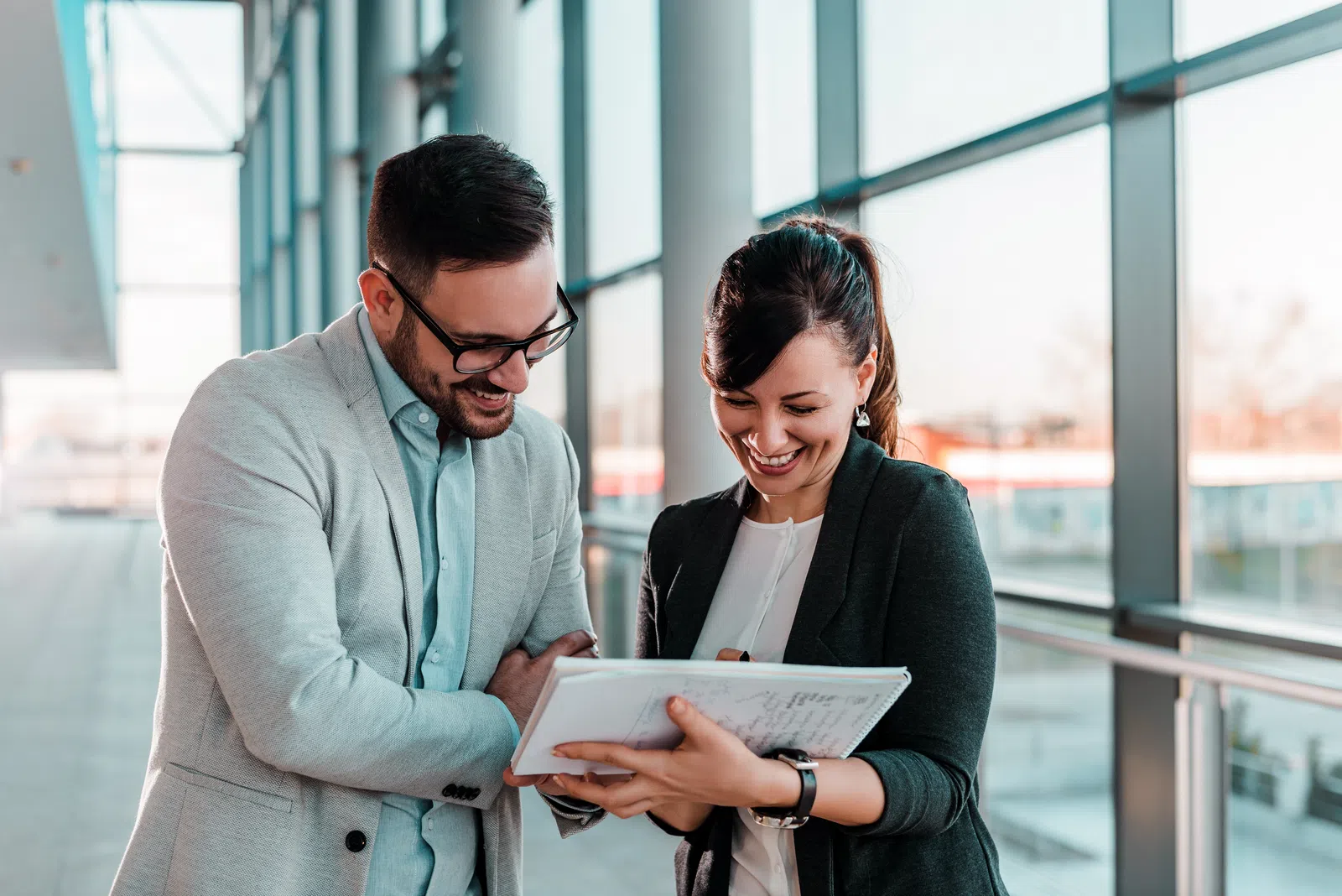 a man and a woman looking at a book
