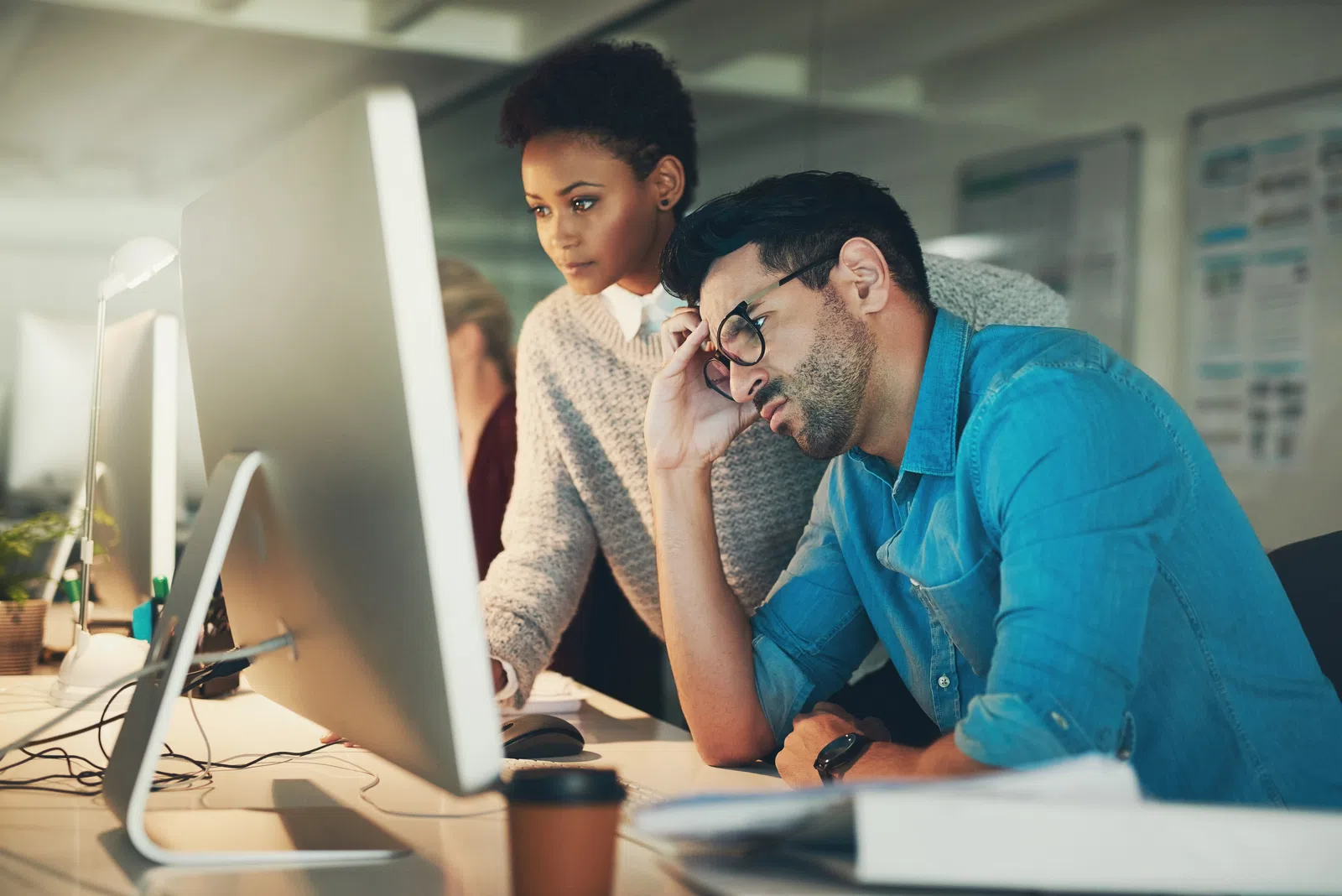 a man and a woman looking at a computer screen