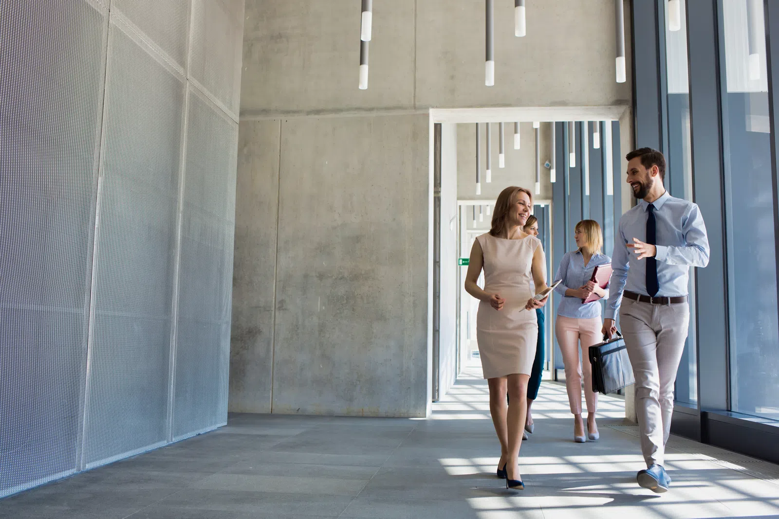 a group of people walking out of a building