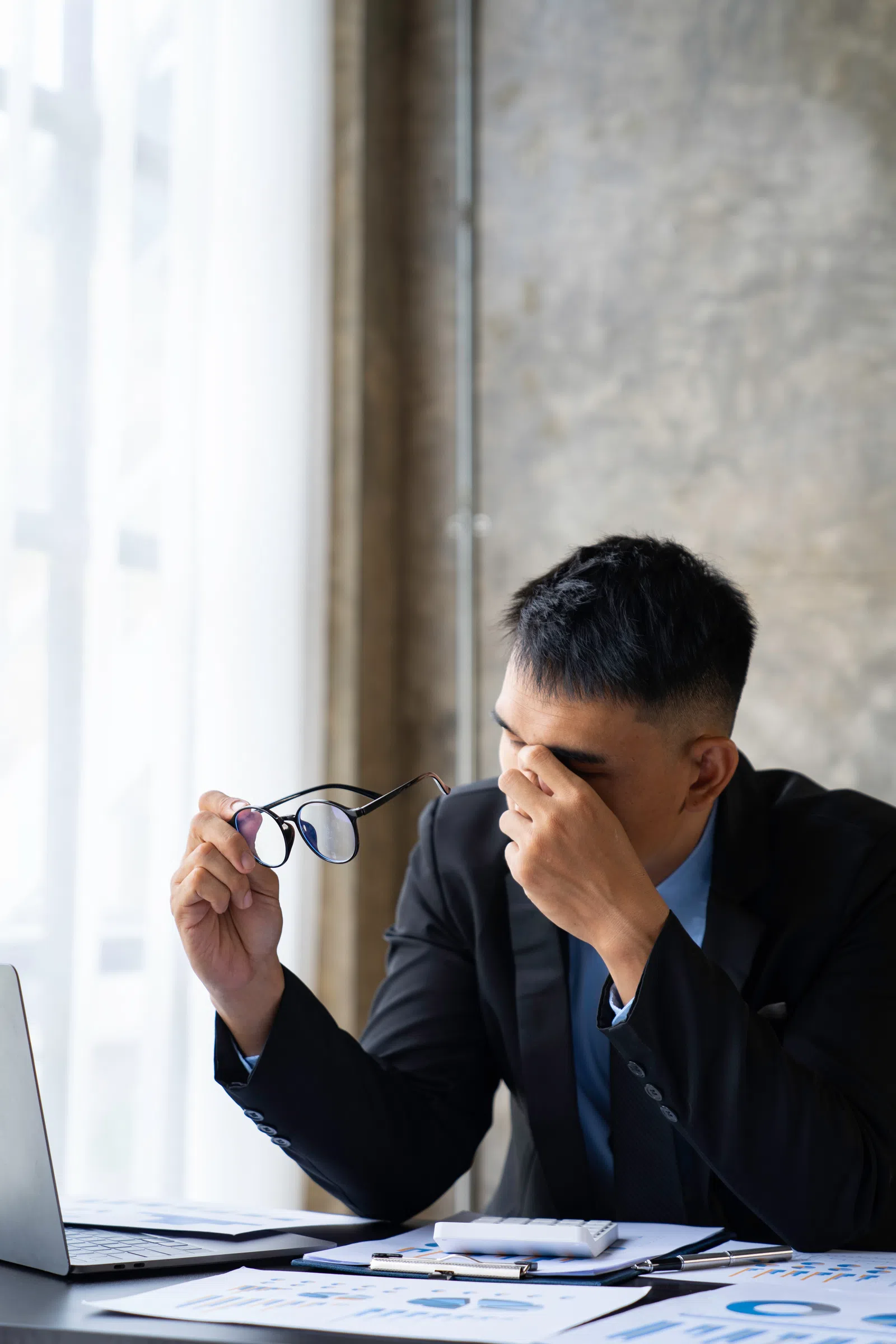 a person sitting at a table with the hand on the face