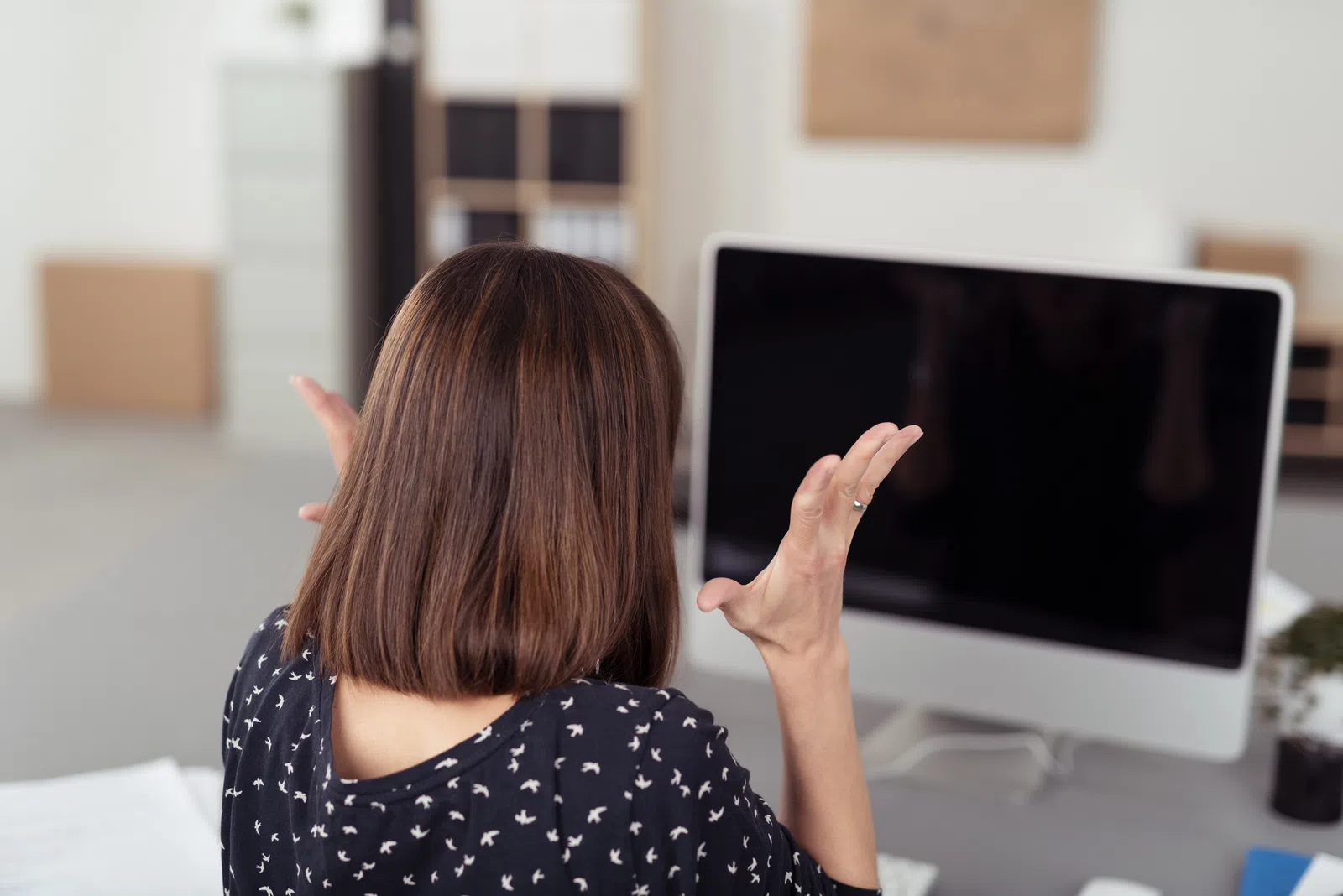 a woman pointing at a screen