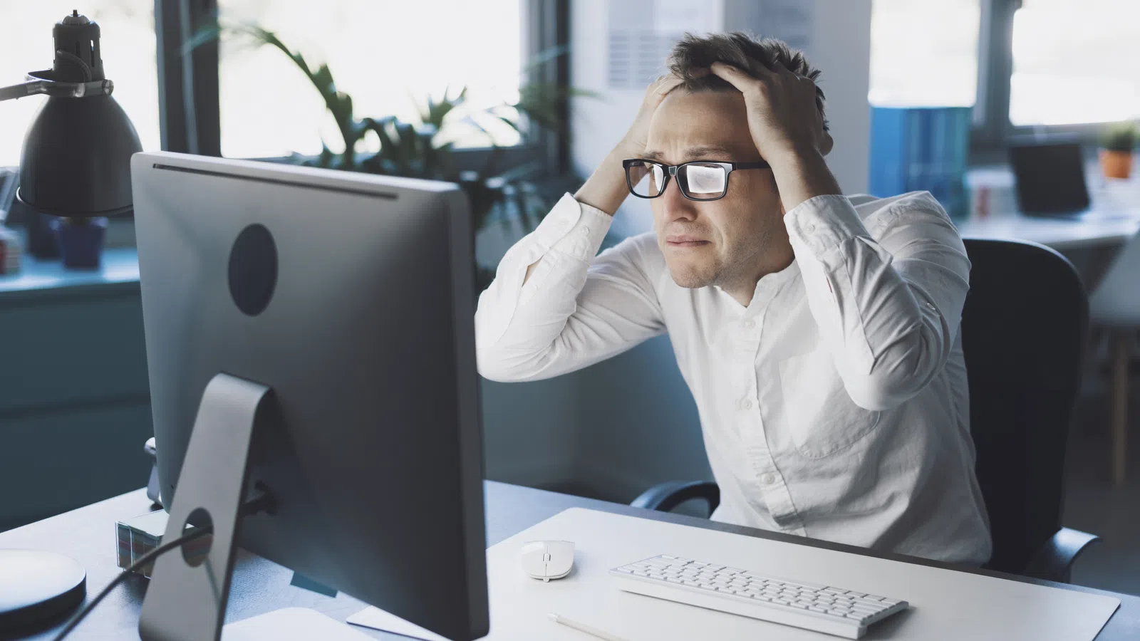 a man sitting at a desk with a computer