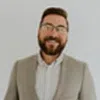 a man with a beard and glasses